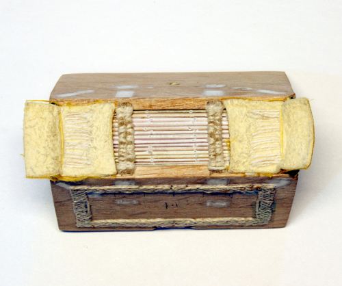 Spine of the spine linings at top and bottom layered with soft chamois and faced with yellow silk cloth. The hand sewn double endbands are structural, being laced through the boards and pegged before being wrapped in green and yellow silk thread.